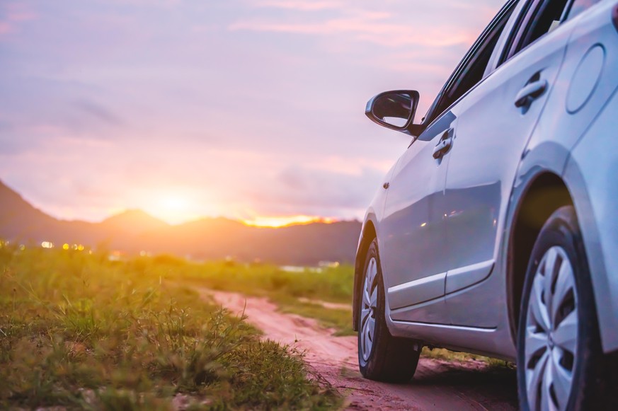 Car with mountain and grassland landscape. Travel and transport concept.