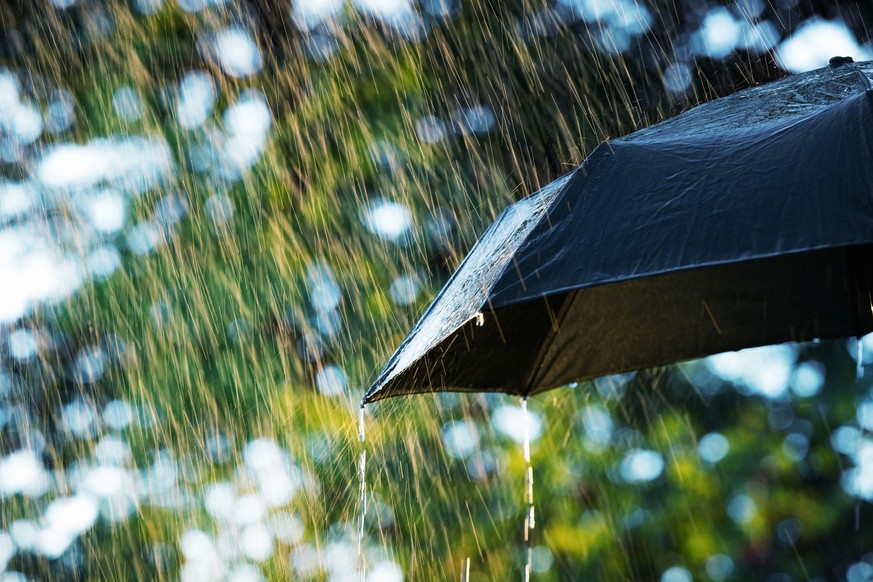 Close up of umbrella in the rain with copy space