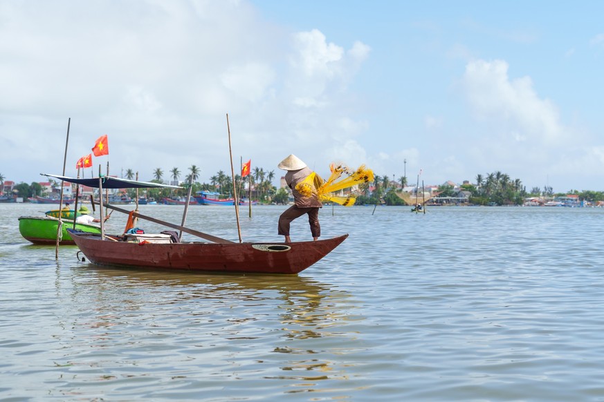 Fisherman Fishing Net on the boat at Cam thanh village. Landmark and popular for tourists attractions in Hoi An. Vietnam and Southeast Asia travel concepts Model Released Property Released xkwx fisher ...