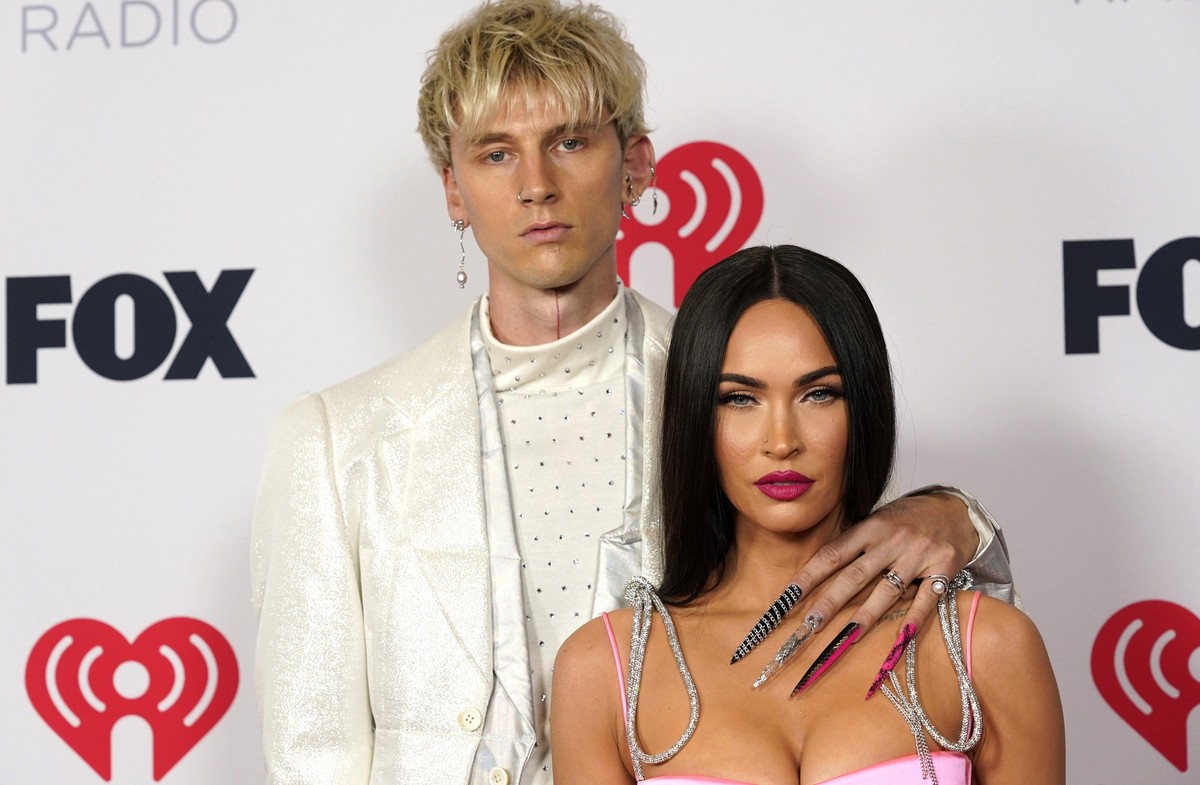 FILE - Megan Fox, right, and Machine Gun Kelly attend the iHeartRadio Music Awards on May 27, 2021, in Los Angeles. (AP Photo/Chris Pizzello, File)