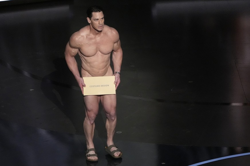 John Cena presents the award for best costume design during the Oscars on Sunday, March 10, 2024, at the Dolby Theatre in Los Angeles. (AP Photo/Chris Pizzello)