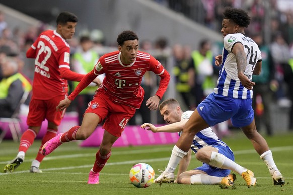 Bayern&#039;s Jamal Musiala, left, and Berlin&#039;s Jessic Ngankam challenge for the ball during the German Bundesliga soccer match between FC Bayern Munich and Hertha BSC Berlin at the Allianz Arena ...