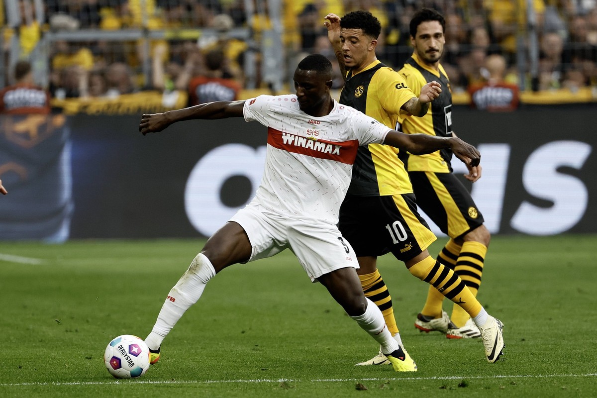 240407 -- DORTMUND, April 7, 2024 -- Serhou Guirassy 1st L of VfB Stuttgart vies with Jadon Sancho of Borussia Dortmund during the first division of Bundesliga football match between Borussia Dortmund ...