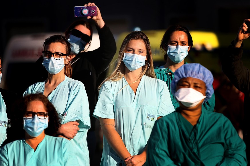 Nurses attend a serenade performed by the Fado music group Serenata ao Luar at Santa Maria Hospital in Lisbon, Portugal on May 12, 2020, to mark the International Nurses Day amid the COVID-19 coronavi ...