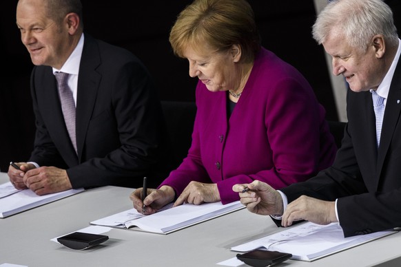 BERLIN, GERMANY - MARCH 12: German Chancellor and Chairwoman of the German Christian Democrats (CDU) Angela Merkel (C), Acting Chairman of the German Social Democrats (SPD) Olaf Scholz (L) and Chairma ...