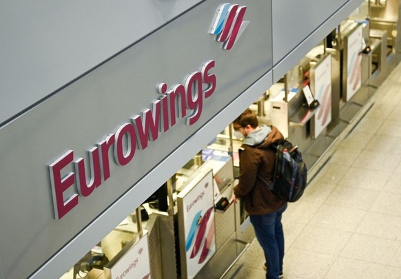 A passenger stands at the check-in counter of Eurowings airline at the Duesseldorf airport, western Germany on October 17, 2022. - Eurowings pilots stage a three-day strike after talks on improving wo ...
