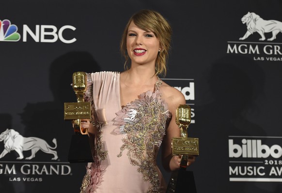 FILE - In this May 20, 2018 file photo, Taylor Swift poses in the press room with the award for top female artist and the award for top selling album for &quot;reputation&quot; at the Billboard Music  ...
