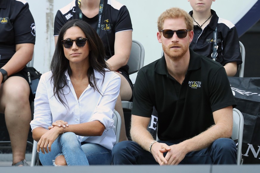 TORONTO, ON - SEPTEMBER 25: Prince Harry (R) and Meghan Markle (L) attend a Wheelchair Tennis match during the Invictus Games 2017 at Nathan Philips Square on September 25, 2017 in Toronto, Canada (Ph ...
