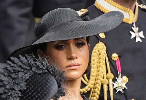 Meghan, Duchess of Sussex watches as the coffin of Queen Elizabeth II is placed into the hearse following the state funeral service in Westminster Abbey in central London Monday Sept. 19, 2022. The Qu ...