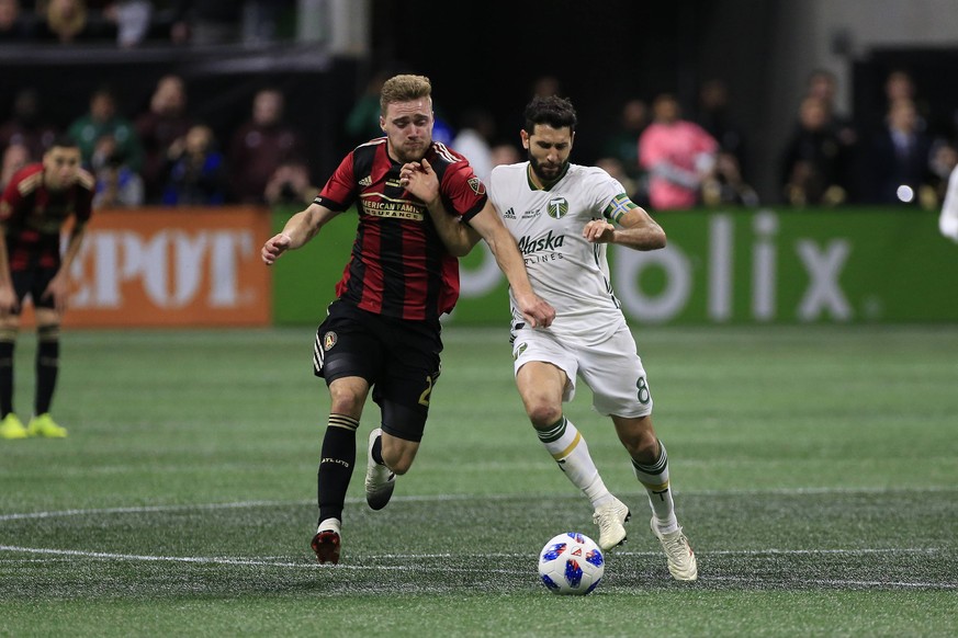 ATLANTA, GA - DECEMBER 08: Atlanta United defender Julian Gressel (24) attacks Portland Timbers midfielder Diego Valeri (8) during the MLS Fussball Herren USA Cup between the Atlanta United FC and the ...