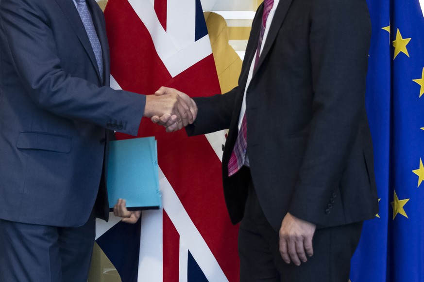 UK Brexit secretary Stephen Barclay, right, shakes hands with European Union chief Brexit negotiator Michel Barnier before their meeting at the European Commission headquarters in Brussels, Friday, Oc ...