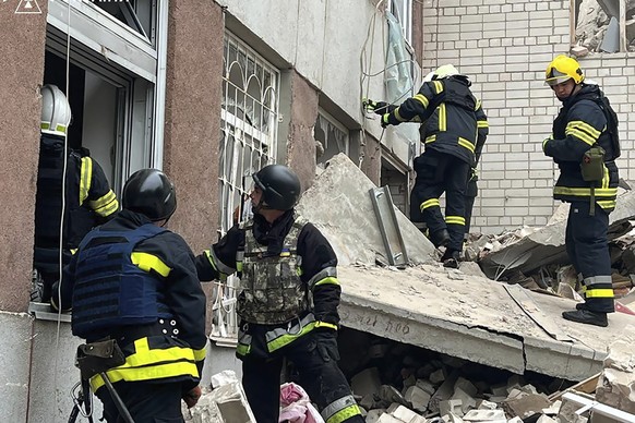 In this photo provided by the Ukrainian Emergency Service, rescuers work at the site of a Russian missile strike in Chernihiv, Ukraine, Wednesday, April 17, 2024. (Ukrainian Emergency Service via AP P ...