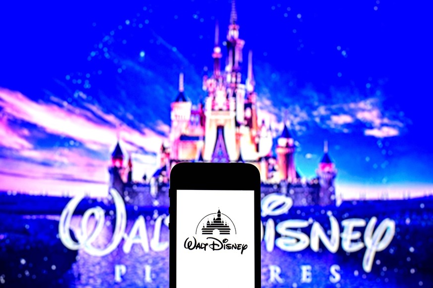 August 3, 2021, Barcelona, Catalonia, Spain: In this photo illustration a Walt Disney Pictures logo seen displayed on a smartphone with a Walt Disney Pictures logo in the background. Barcelona Spain - ...