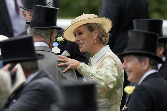 Zara Tindall, centre, speaks to Britain&#039;s King Charles III as they arrive for day one of the Royal Ascot horse racing meeting, at Ascot Racecourse in Ascot, England, Tuesday, June 20, 2023.(AP Ph ...