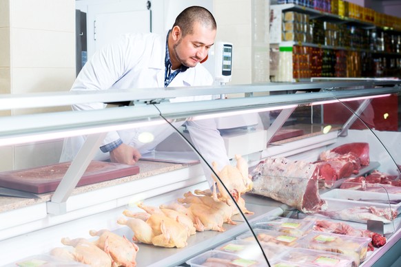 Portrait of male seller in halal section at supermarket