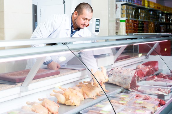 Portrait of male seller in halal section at supermarket