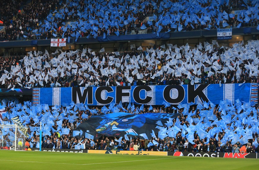 17th April 2019, Etihad Stadium, Manchester, England; UEFA Champions League football, quarter final 2nd leg, Manchester City versus Tottenham Hotspur; Manchester City fans wave flags and hold a banner ...