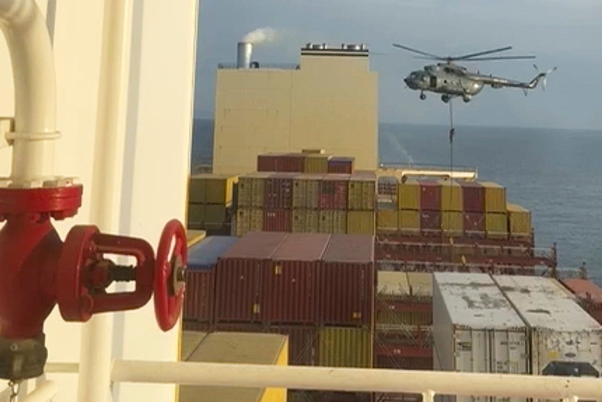 This image made from a video provided to The Associated Press by a Mideast defense official shows a helicopter raid targeting a vessel near the Strait of Hormuz on Saturday, April 13, 2024. A video se ...