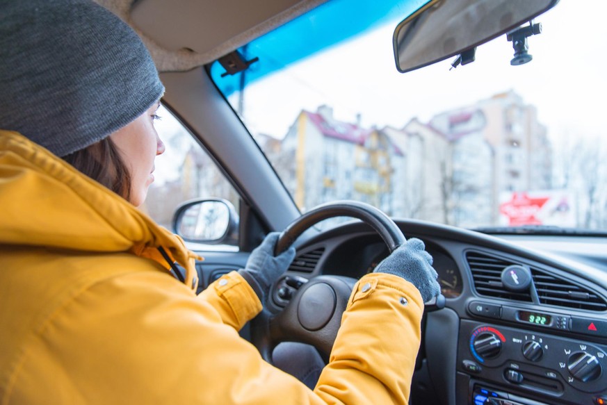 woman drive car in cold winter weather