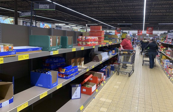 March 13, 2020, Bloomington, United States: Shoppers panic buy food at an Aldi grocery store in Bloomington..The woman on the right said, I ve got three kids, I ve gotta do what I ve gotta do. United  ...