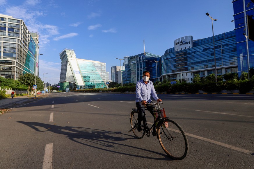 April 19, 2020, Delhi, India: A Cyclist wearing a face mask as a preventive measure against the spread of coronavirus rides on an empty street..India has recorded a total of 17,655 confirmed case, 2,8 ...
