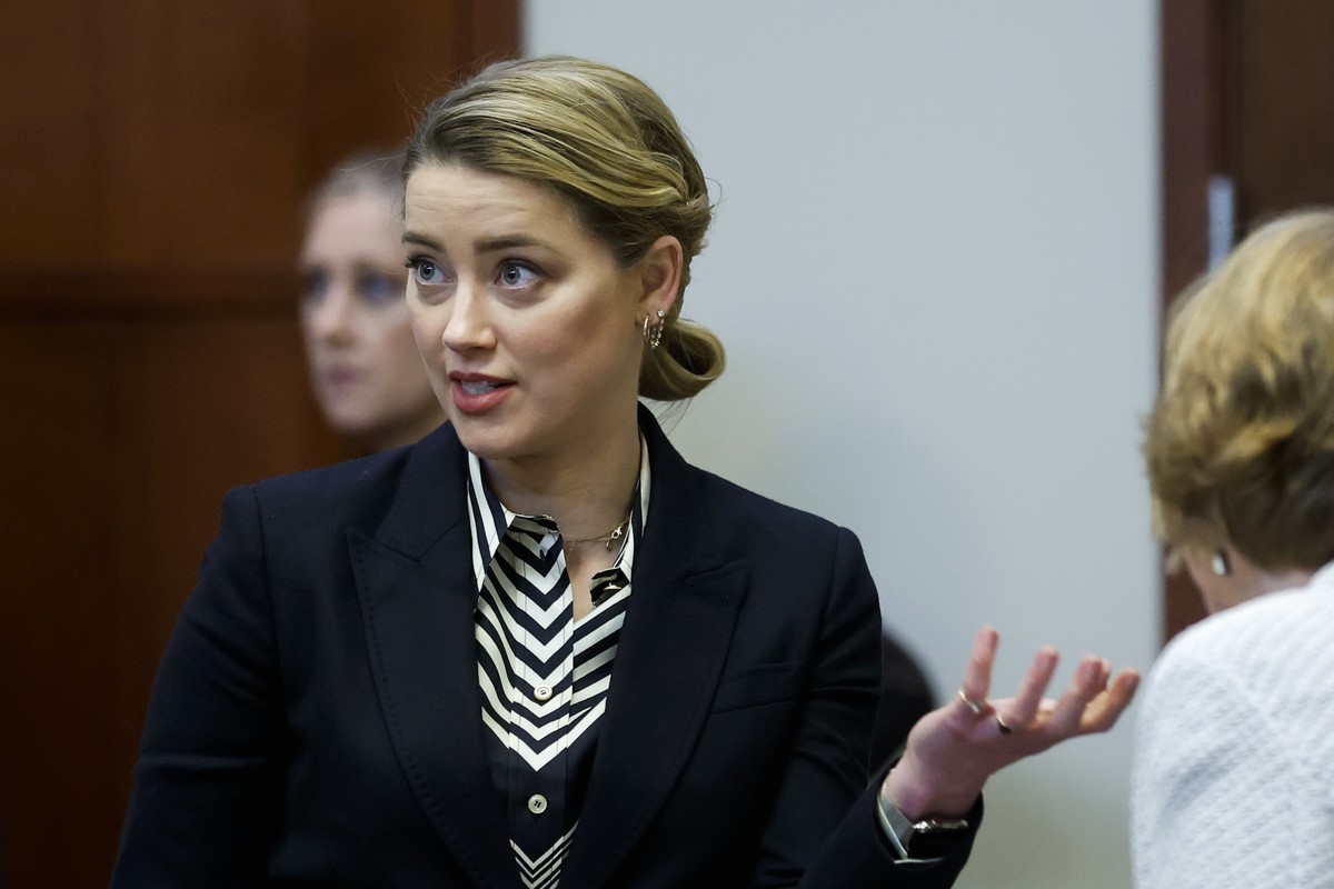 Actor Amber Heard speaks to her legal team in the courtroom at the Fairfax County Circuit Court in Fairfax, Va., Wednesday, April 27, 2022. Actor Johnny Depp sued his ex-wife actress Amber Heard for l ...