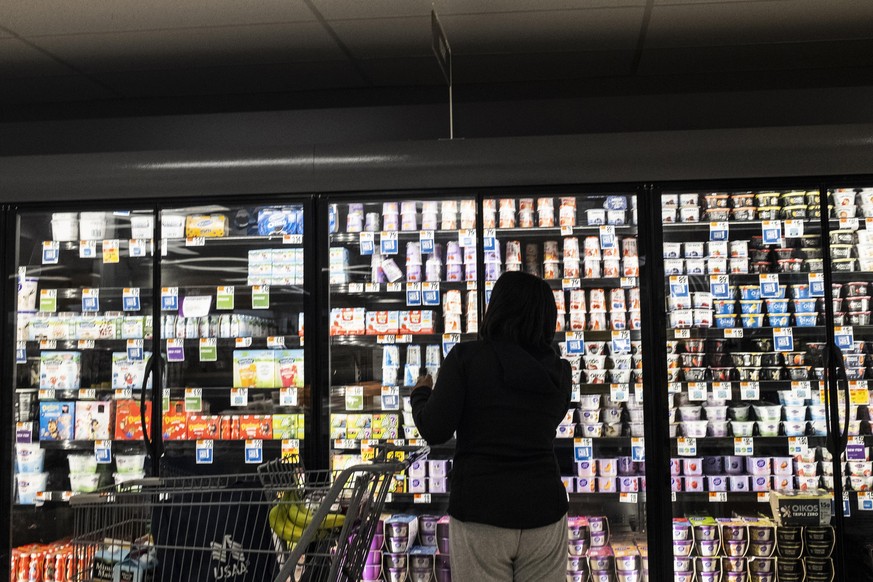 NORTH BETHESDA, MARYLAND - APRIL 12: People shop for groceries at a Giant Food supermarket on April 12, 2022 in North Bethesda, Maryland. The Bureau of Labor Statistics announced the latest inflation  ...