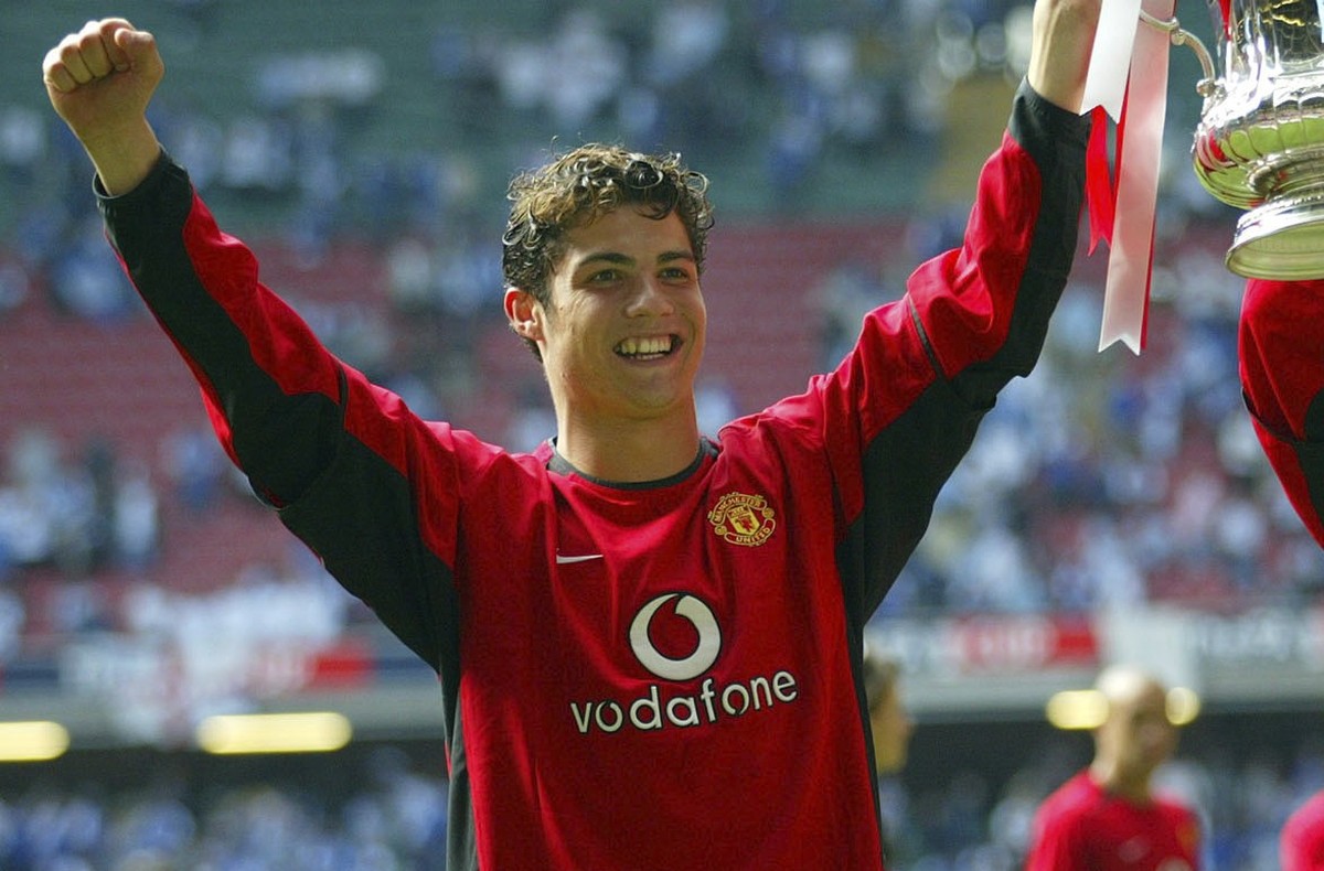 FILE - Manchester United&#039;s Cristino Ronaldo, left, holds the trophy aloft with teammate Ruud van Nistelrooy at the end of the FA Cup final between Millwall and Manchester United at the Millennium ...