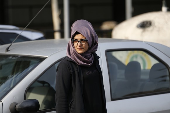 A woman who identified herself as Hatice A., the Turkish fiancee of Saudi journalist Jamal Khashoggi, walks outside the Saudi Arabia consulate in Istanbul, Wednesday, Oct. 3, 2018. Khashoggi, who has  ...