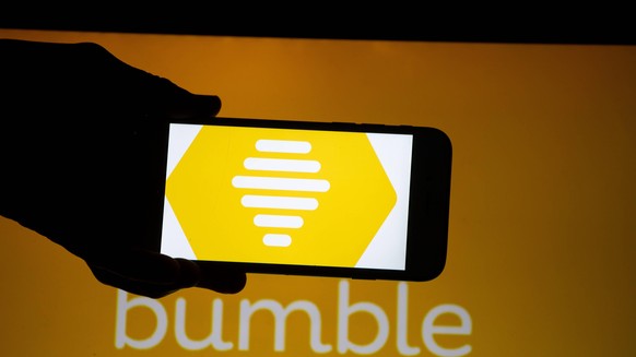 August 20, 2018 - Munich, Bavaria, Germany - The logo of the dating app Bumble is seen on a mobile screen and a laptop screen. It was founded by a former Tinder employee. Several Millions use Dating A ...
