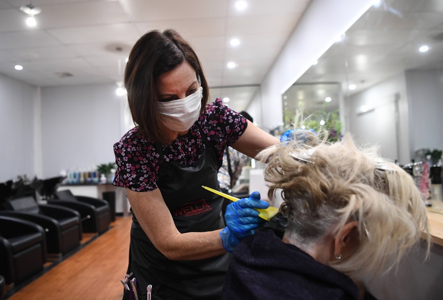AUSTRALIA CORONAVIRUS COVID-19, Hairdresser Heather first name only given colours a customer s hair, for the last time in the foreseeable future due to newly announced time restrictions, in Brisbane, ...