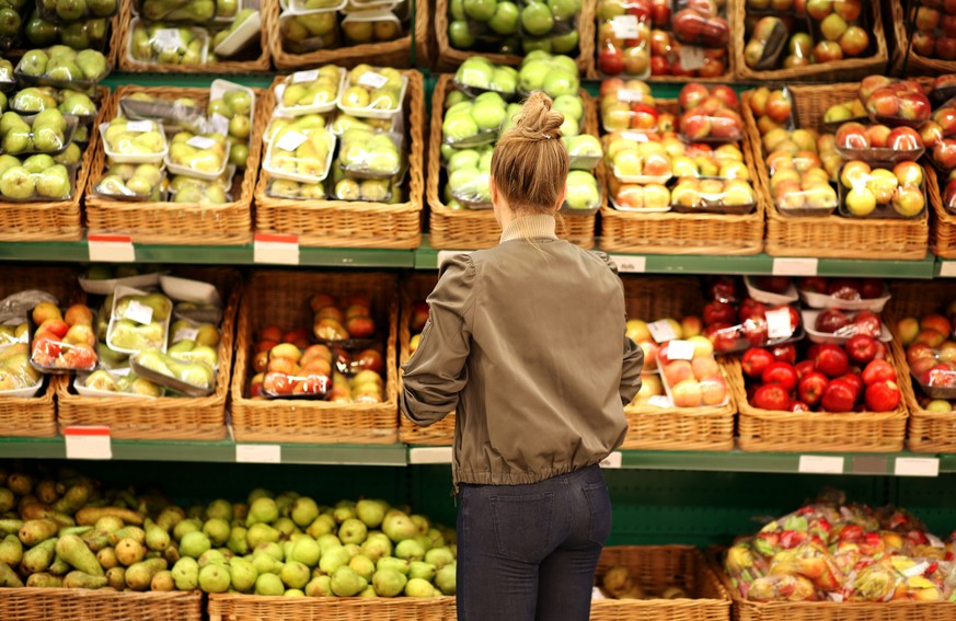 Middle-age woman buying vegetables at the market