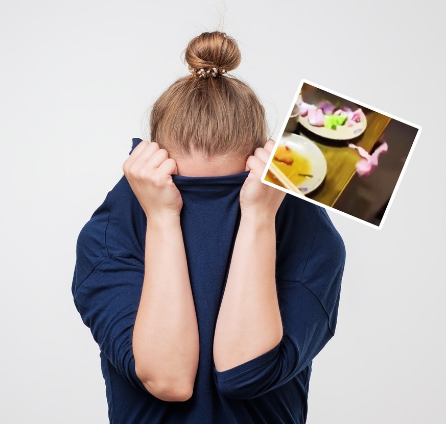 European woman hiding face under the clothes. She is oulling sweater on her head. Depressed emotion. Wish to be alone.