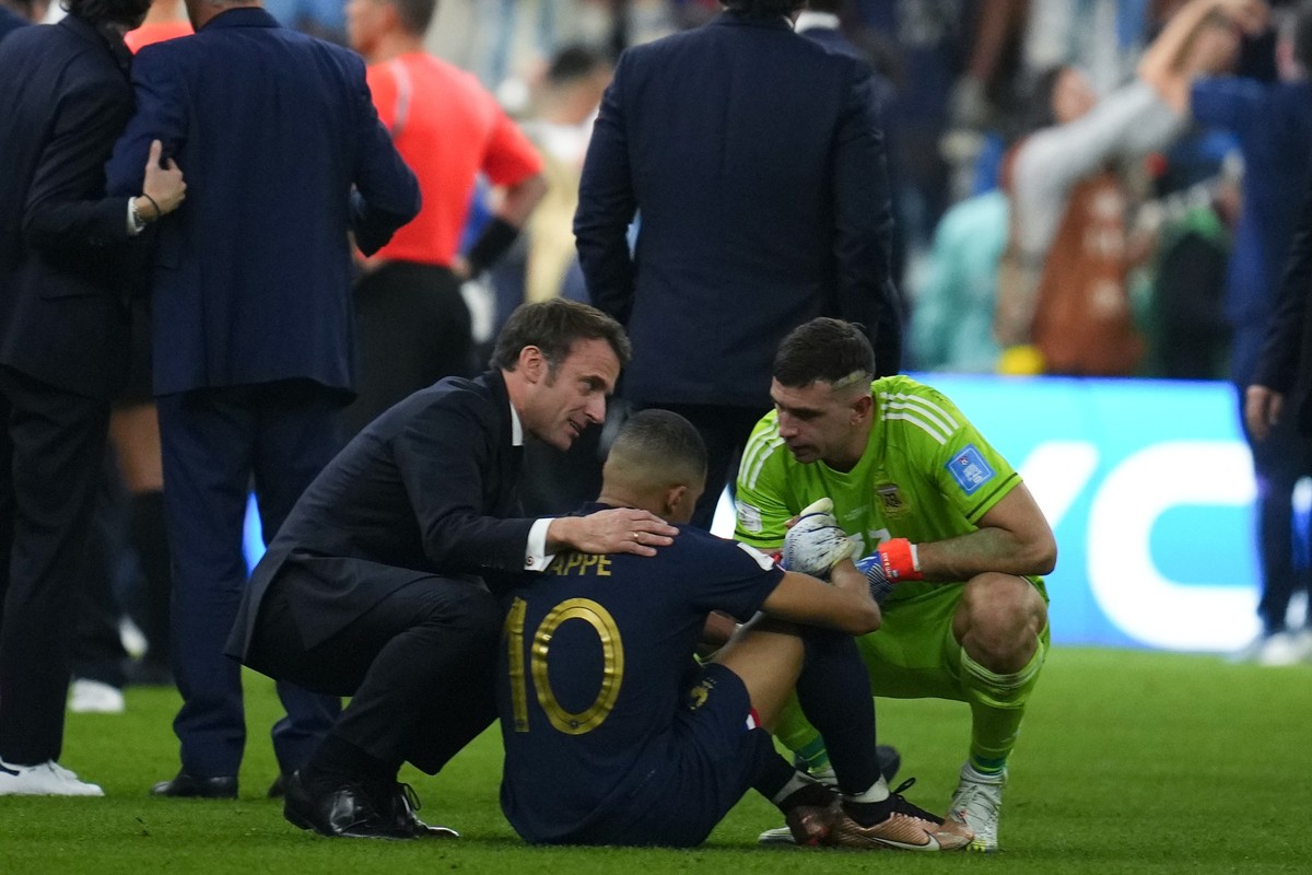 France&#039;s President Emmanuel Macron and goalkeeper Emiliano Martinez confort France&#039;s Kylian Mbappe at the end of the World Cup final soccer match between Argentina and France at the Lusail S ...