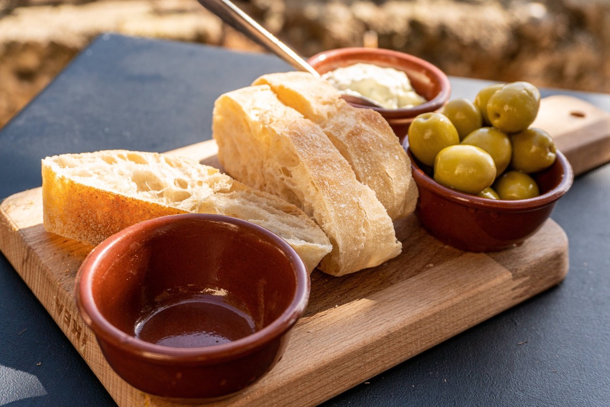 Spanish tapas Spanish appetizer with three slices of white bread, aioli and olives on a wooden board Copyright: xZoonar.com/TorstenxEismannx 18790272