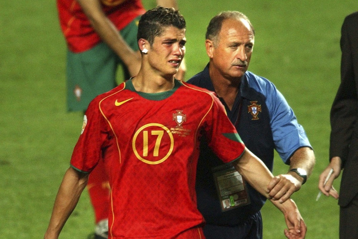 FILE - Portugal coach Luiz Felipe Scolari, right, leads a tearful Cristiano Ronaldo to collect his runners-up medal after Greece beat Portugal 1-0 in the Euro 2004 soccer championship final match at t ...