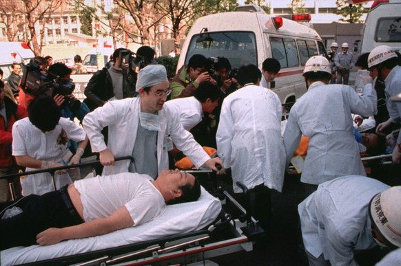 FILE - In this March 20, 1995 file photo, subway passengers affected by sarin nerve gas in the central Tokyo subway trains are carried into St. Luke&#039;s International Hospital in Tokyo. Tuesday, Ma ...