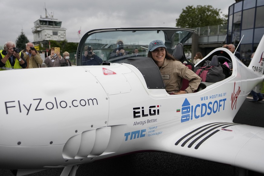 Belgian-British teenager Zara Rutherford smiles from her Shark Ultralight airplane prior to take off at the Kortrijk-Wevelgem airfield in Wevelgem, Belgium, Wednesday, Aug. 18, 2021. A Belgian-British ...