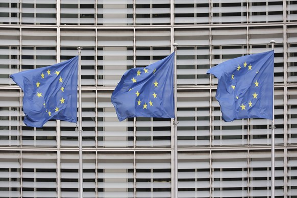 EU Flags In Brussels Flags of Europe as seen waving on a pole. The European Flag is the symbol of Council of Europe COE and the European Union EU as seen in the Belgian capital in front of the Le Berl ...