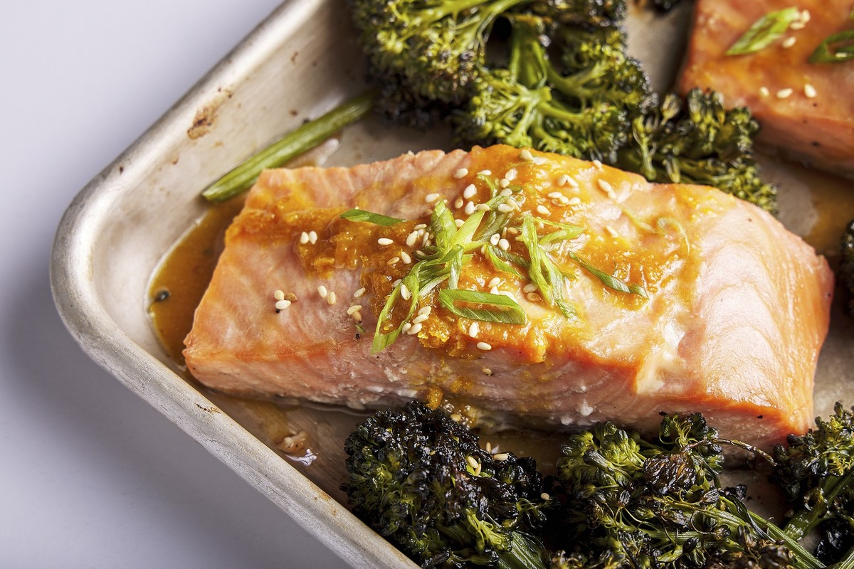 This image released by Milk Street shows a recipe for honey-miso salmon and broccolini traybake. (Milk Street via AP)