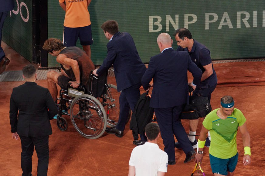 220604 -- PARIS, June 4, 2022 -- Alexander Zverev leaves the court in a wheelchair as he retires from the match after sustaining an injury during the men s singles semifinal match between Alexander Zv ...