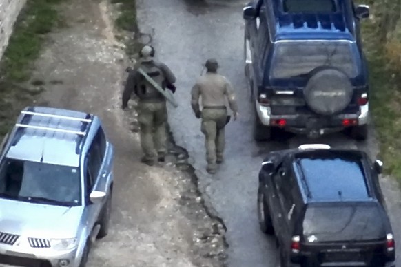 In this photo provided by the Kosovo Police, a group of armed, masked men stand in front of the Banjska Monastery in the same village in North Kosovo, on Sunday, Sept. 24, 2023. Kosovo&#039;s prime mi ...