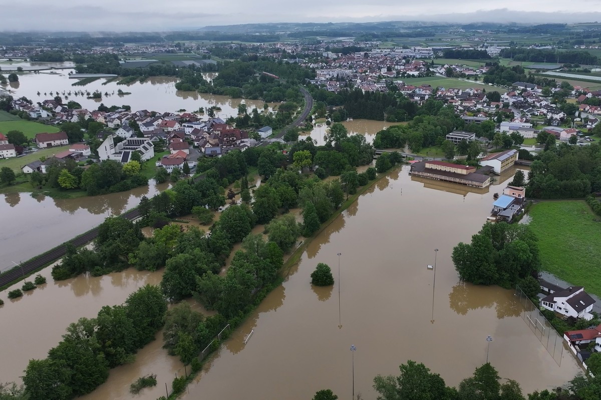 02.06.2024, Baden-Württemberg, Meckenbeuren: Das Hochwasser des Flusses Schussen überschwemmt Teile von Meckenbeuren. Die Schule (rechts) ist nach dem Hochwasser vor drei Jahren wieder unter Wasser. ( ...