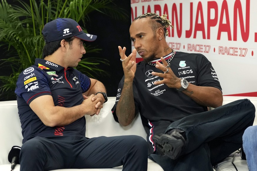 Red Bull driver Sergio Perez, left, of Mexico and Mercedes driver Lewis Hamilton of Britain attend a press conference ahead of the Japanese Formula One Grand Prix at the Suzuka Circuit in Suzuka, cent ...