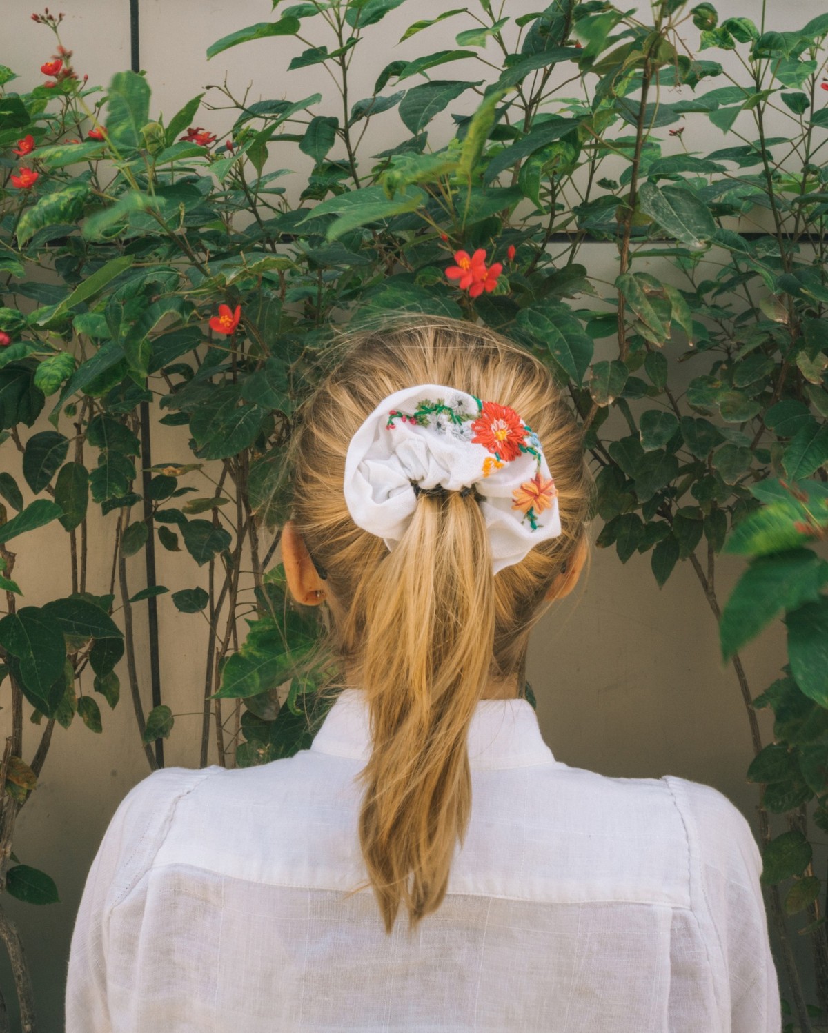 Young woman in the garden rear view