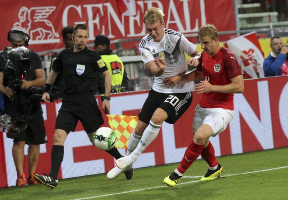 Germany's Julian Brandt fights for the ball with Austria's Thomas Murg, right, during a friendly soccer match between Austria and Germany in Klagenfurt, Austria, Saturday, June 2, 2018. (AP Photo/Rona ...