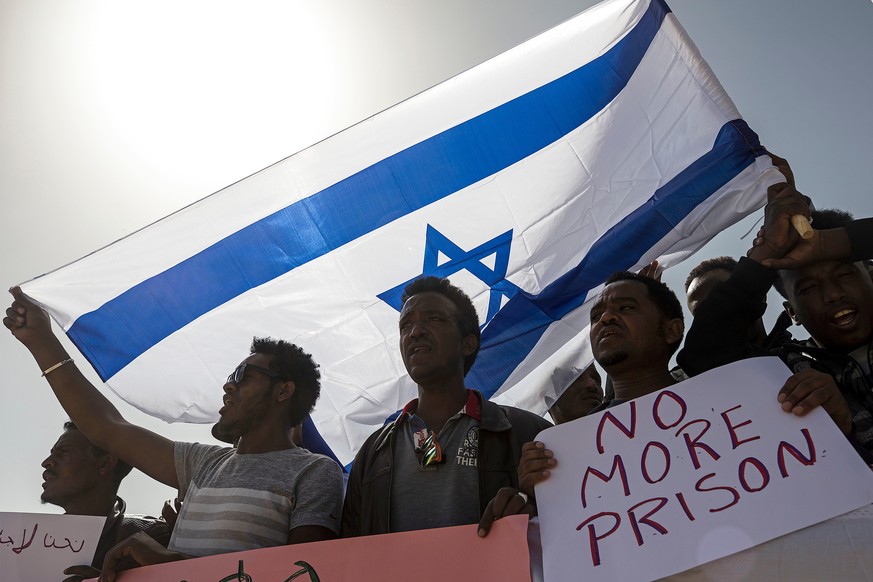 FILE - In this Feb. 22, 2018 file photo, asylum seekers march during a protest outside Israeli Prison Saharonim, in the Negev desert, southern Israel. Prime Minister Benjamin Netanyahu&#039;s office s ...