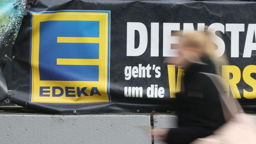 BERLIN, GERMANY - FEBRUARY 19: A young woman walks past a grocery store of German chain Edeka on February 19, 2018 in Berlin, Germany. According to media reports Agecore-Group, to which Edeka belongs, ...