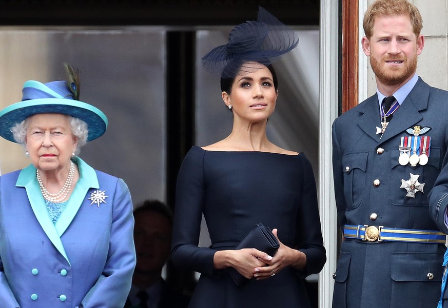 LONDON, ENGLAND - JULY 10: Queen Elizabeth II, Prince Harry, Duke of Sussex and Meghan, Duchess of Sussex on the balcony of Buckingham Palace as the Royal family attend events to mark the Centenary of ...