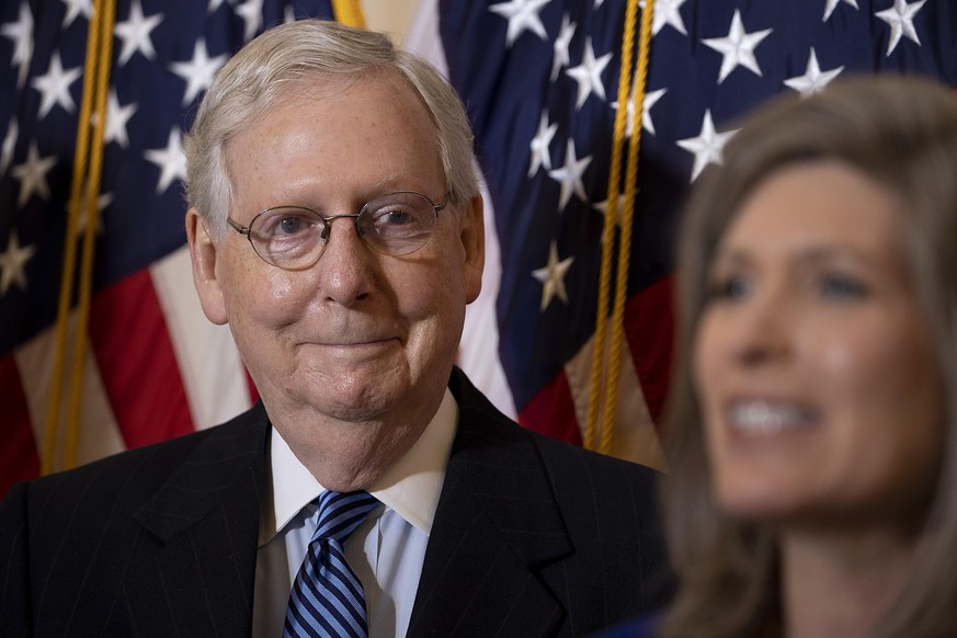 WASHINGTON, DC - NOVEMBER 10: Senate Majority Leader Mitch McConnell (R-KY) listens to Sen. Joni Ernst (R-IA) speak to the media at the US Capitol on November 10, 2020 in Washington, DC. Senators held ...